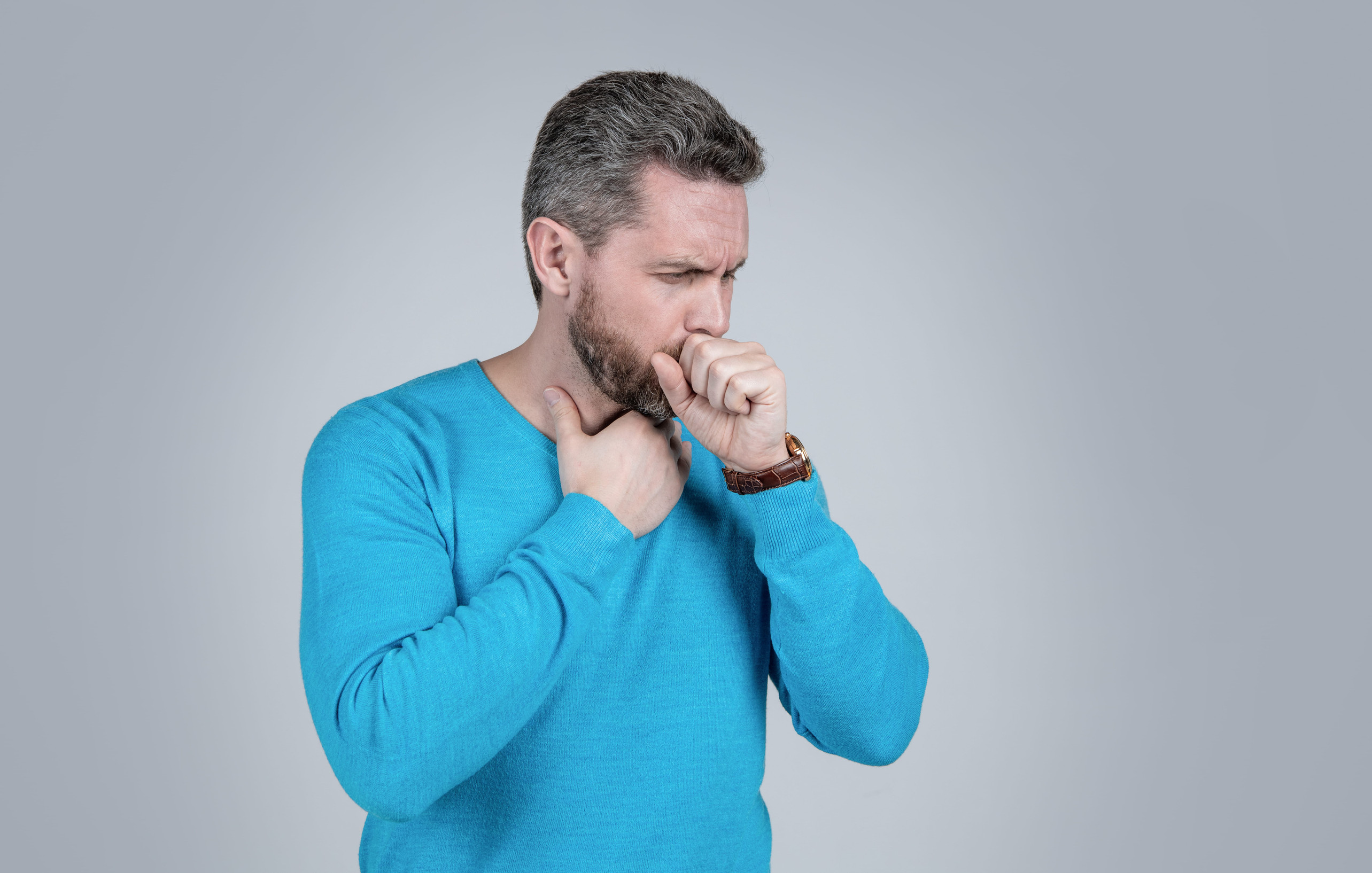 Man experiencing bronchitis cough symptoms