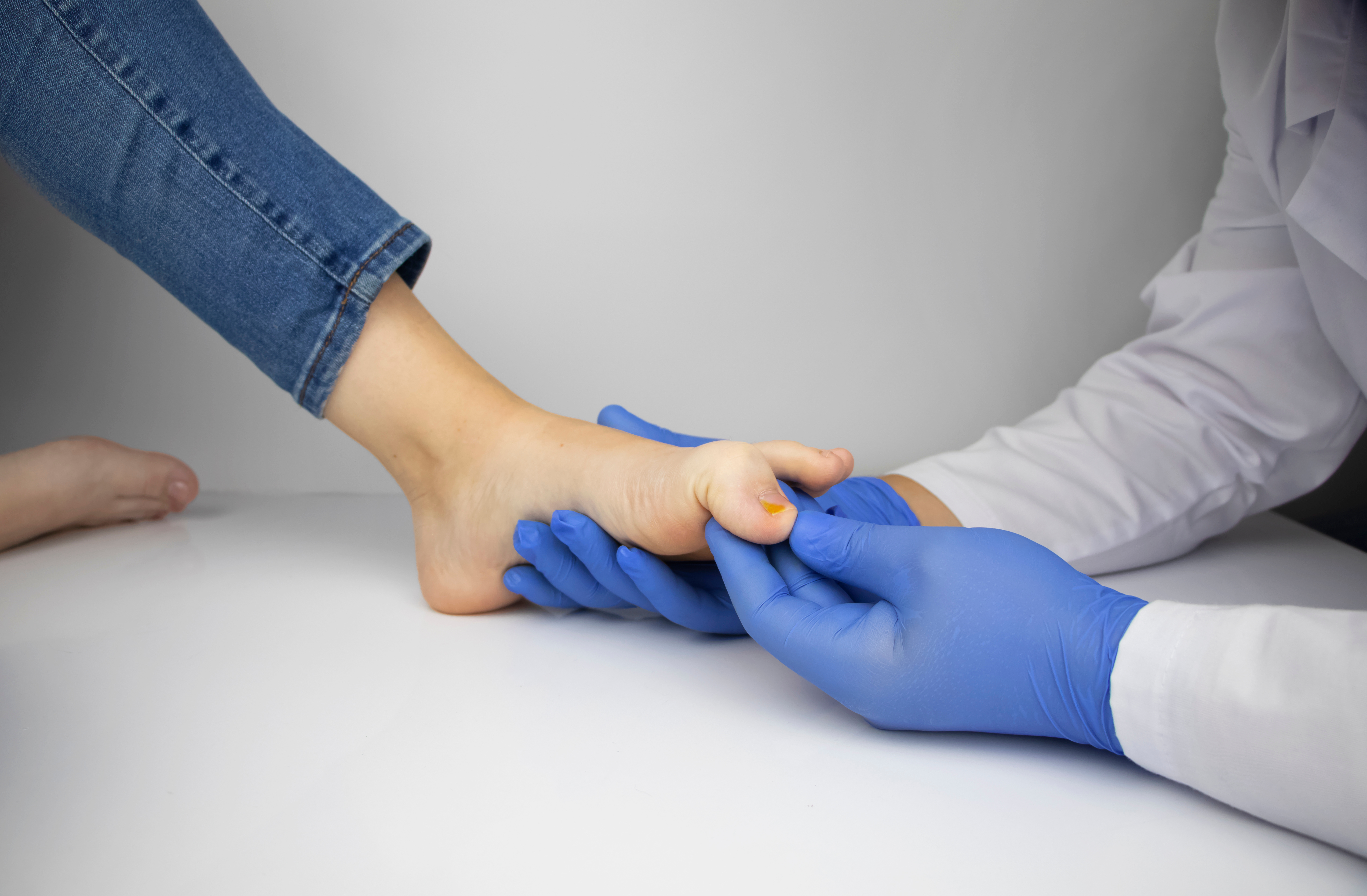 Doctor examining patient's foot for neuropathy symptoms